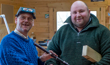 Martin Doyle presents a keyed flute to his friend and part-time assistant Brian Morgan, who is a local flute player.
